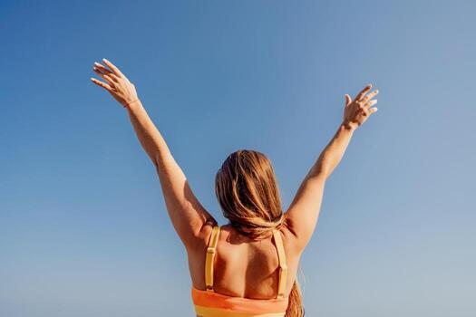 A woman with long hair is standing in the sun photo