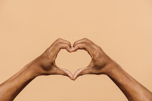 Black male hands showing a heart shape photo