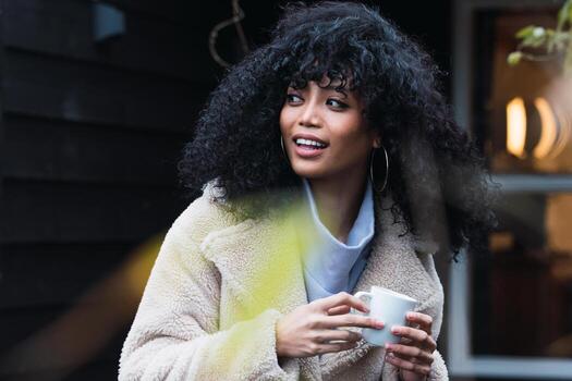 Smiling black woman with cup of coffee photo